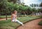 Child with rose flower in spring garden