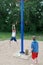 Child on rotating rope swing around central pole