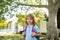 Child with rucksacks standing in the park near school. Pupils with books and backpacks outdoors. Kids education concept.