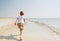 Child running along beach