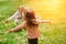 Child running into mother`s hands to hug her. Family having fun in the park.