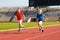 Child running in stadium. Kids run. Healthy sport