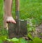 Child`s bare foot on the metal spade