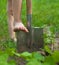 Child`s bare foot on the metal spade