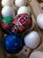 A Child`s Easter Pysanka Resting on top of an Egg Carton