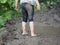 Child`s feet covered with dirt.