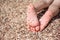 Child\'s feet on the pebbles beach