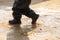 Child`s feet in rubber boots stained in spring mud