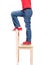 Child\'s feet standing on the little chair