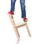 Child\'s feet standing on the little chair