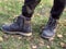 The child\\\'s feet are wearing winter lace-up shoes