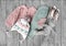 Child`s girl knitwear set on wooden background flat lay. Kid`s winter woolen clothes top view. Toddler knitted cardigan,pants,ha