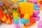 Child`s hand building plastic toy blocks with blurred background