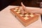 child`s hand on the chessboard showing thumb up. cool game at home