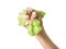 A child`s hand crushes a green lime isolated on a white background.