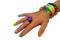 A child\'s hand decorated with rubber bands loom