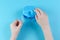 Child`s hand with orthodontic appliance with box on blue background