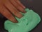 Child`s hand poking bright green slime