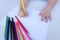 The child`s hand preparing to write on a white sheet of paper with colored pencils.  Education and children activities concept