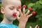 Child\'s hand with raspberry on fingers