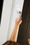 Child\'s hand on secure window handle