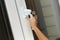 Child\'s hand on secure window handle