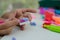 Child`s hands with colored plasticine.