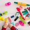 Child`s hands with colorful clay. Toddler playing and creating toys from play dough. Boy molding modeling clay