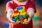 Child\\\'s hands cradling an assortment of vibrant building blocks, emphasizing creativity and cognitive growth