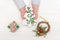 Child`s hands holding ornamental christmas tree near gift boxes on white table