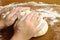 Child\'s hands kneading bread dough