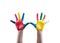 Child\'s hands painted with multicolored finger paints