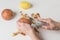 The child`s hands perform peeling potatoes using a vegetable peeler.