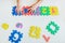 Child`s hands playing with numbers, learning simple multiplication. Colorful bright puzzle numbers on white background, education