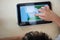 Child& x27;s hands playing tablet computer