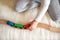 Child`s hands playing with toy wooden trains on railway.