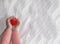 Child`s hands with a red heart on a background of white crumpled fabric. Cardiology concept, mother`s day, social poster, family