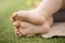 A child`s legs barefoot on grass