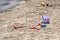 A child`s losted plastic sand buckets raker and scoop at the beach. Sunny day on Mediterranean sea