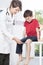 Child\'s neurologist testing knee reflex