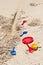 Child`s plastic, colorful, shovels, rake, pans, on brown, sandy  beach