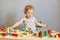 Child\\\'s playful journey of discovery. Curious child\\\'s playful learning. Wavy haired blonde infant