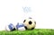Child\'s shoes with rubber ball on grass