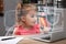 Child safety online. Little girl using laptop at home. Illustration of internet blocking app
