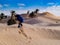 child in the Sahara desert plays with the sand of the dunes, tourist on vacation