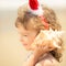 Child in Santa hat at the beach