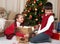 Child in santa hat having fun and playing, sharing gifts, christmas decoration at home, happy emotion, winter holiday concept