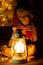 Child in Santa red hat wrapped in a garland on a dark background with lights . New year magic. Christmas concept