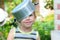 A child with a saucepan on his head. child with a saucepan. Happy child indulges. A child in a saucepan hat.