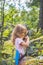 Child, scout in the forest with walkie-talkie